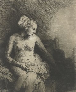 A woman at the bath with a hat beside her